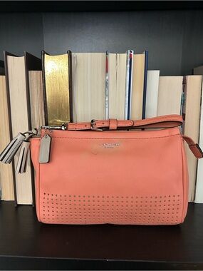 COACH Legacy Perforated Leather Wristlet in Coral with Tan Tassels